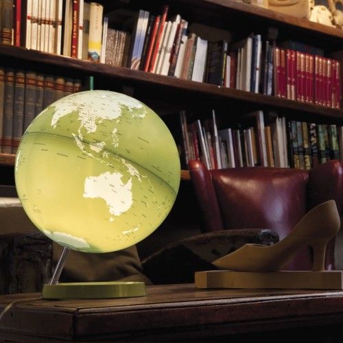 Illuminated terrestrial globe in white and green design on pistachio-colored base